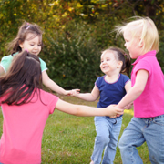 Children playing ring around the rosey